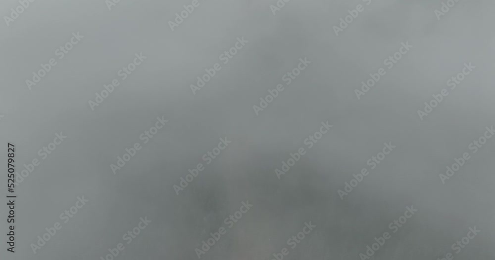 Aerial of low fog hanging over mountain and forest trees. Aerial of low fog hanging over mountain and forest trees.