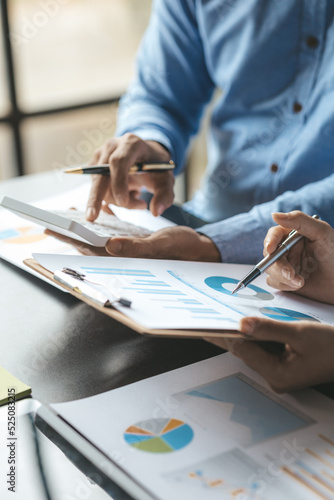 Fototapeta Naklejka Na Ścianę i Meble -  Company meeting room has businessmen and finance managers meeting together on finance topics, they are looking at information on documents and discussing together. Concept company financial management