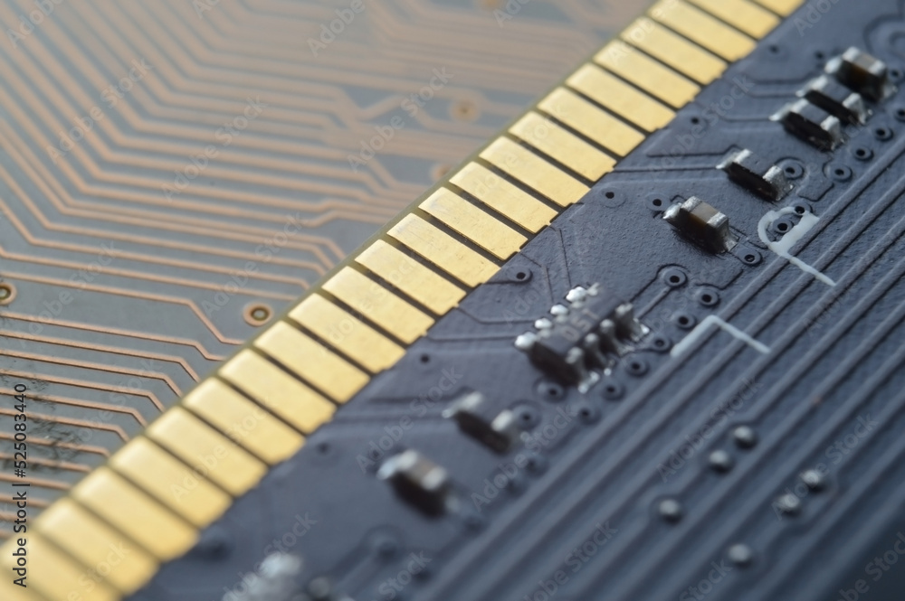 the RAM module from the computer lies on top of the motherboard. close-up the RAM module from the computer lies on top of the motherboard. close-up