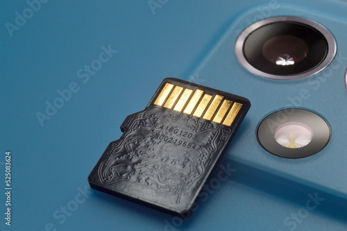micro sd card lies on the block of smartphone cameras. close-up