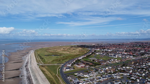 Aerial view of the coast with  sea and blue sky and buildings and houses. Taken in Fleetwood Lancashire England. 