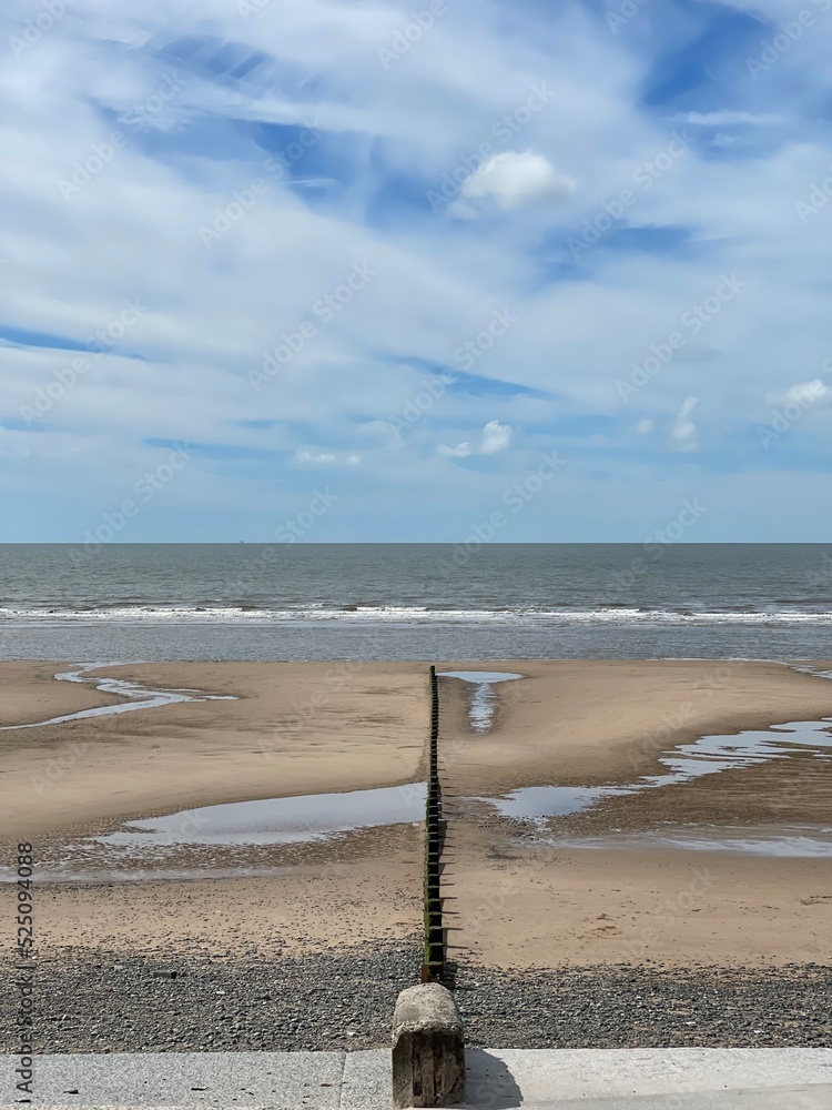 Aerial view of the beach with waves and a blue sky background with clouds. Taken in Fleetwood Lancashire England. Aerial view of the beach with waves and a blue sky background with clouds. Taken in Fleetwood Lancashire England.