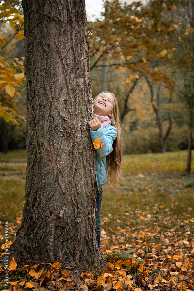 beautiful girl with long blonde hair staying near tree in autumn park beautiful girl with long blonde hair staying near tree in autumn park