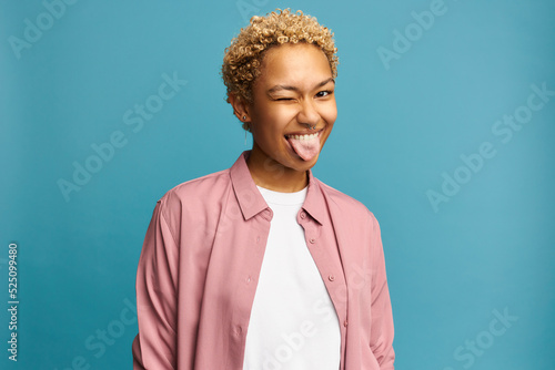 Canvastavla Portrait of funny black girl with blond curly hair showing tongue winking with o