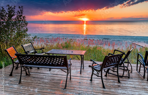 Relaxing point at sandy beach of the Baltic Sea,  Europe. Colorful sunrise, c...
