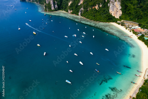 Aerial photo of Koh phi phi island in thailand with turquoise sea along with village and harbor