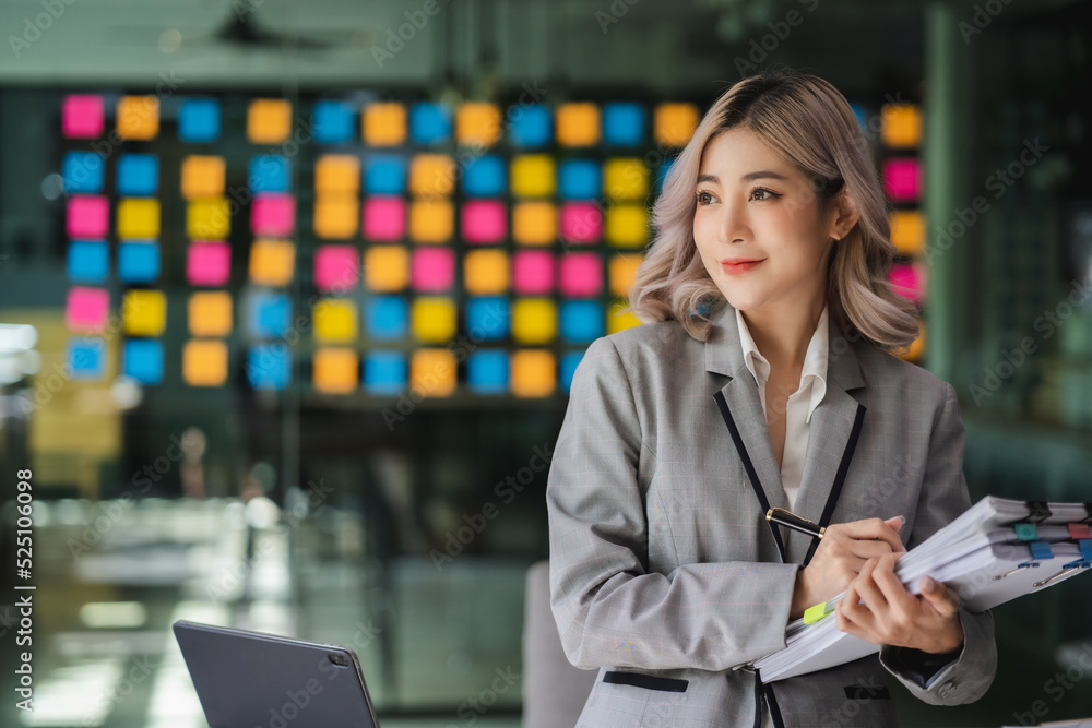 Young beautiful Asian business woman hold paper account documents informal spreadsheet financial Accountant consulting work stand review report. Young beautiful Asian business woman hold paper account documents informal spreadsheet financial Accountant consulting work stand review report.