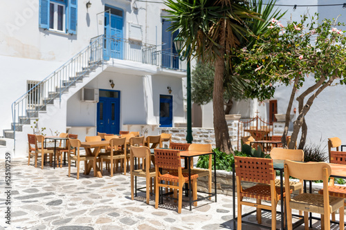 City centre and streets of village of Tinos with Cycladic houses, cafe and shops on Tinos island, Cyclades, Greece