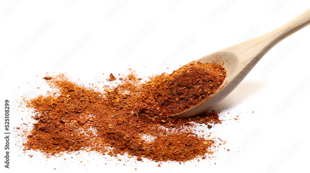 Spicy chili pepper flakes, crushed, milled red paprika pile in wooden spoon isolated on white 