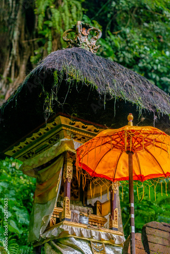 Tendung: Balinese temple umbrella in front a offering temple.
