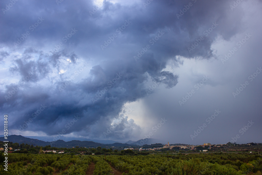 Summer storm, with clouds about to dump rain on a small town in the Mediterranean hinterland.
