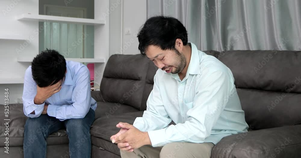 Homosexual male express sad or bad emotion from arguement or controversial problem. on sofas inside their homes, LGBTQ concept. Homosexual male express sad or bad emotion from arguement or controversial problem. on sofas inside their homes, LGBTQ concept.