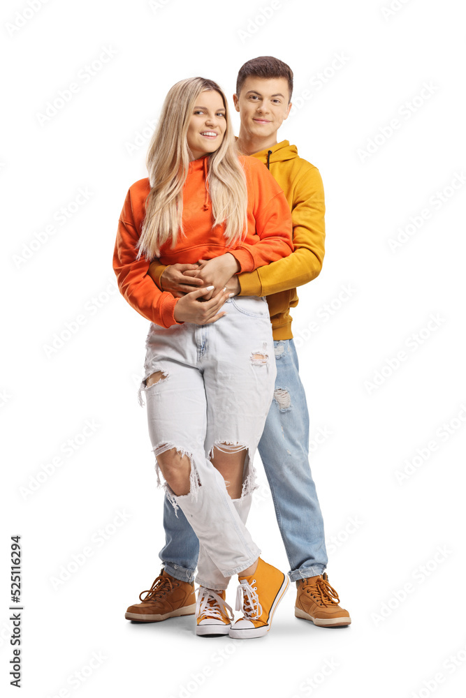 Teenage couple in embrace looking at camera Teenage couple in embrace looking at camera