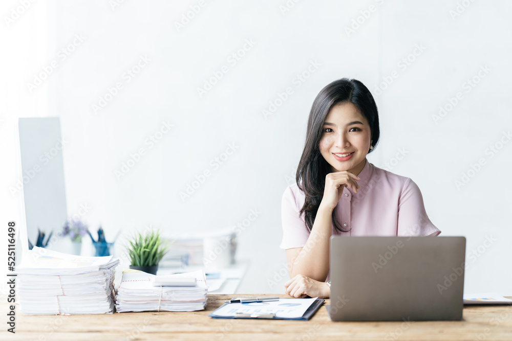 Asian woman working with laptop in her office. business financial concept. Asian woman working with laptop in her office. business financial concept.