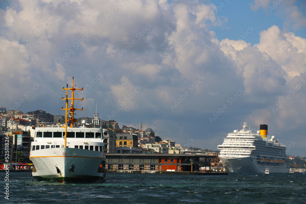 selective focus: big tourist ship and passenger ferry in istanbul eminonu