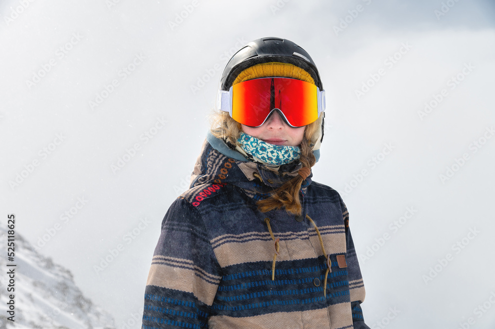 Macro portrait. Young adult woman, snowboarder or skier in a snowy winter on a mountain slope Macro portrait. Young adult woman, snowboarder or skier in a snowy winter on a mountain slope
