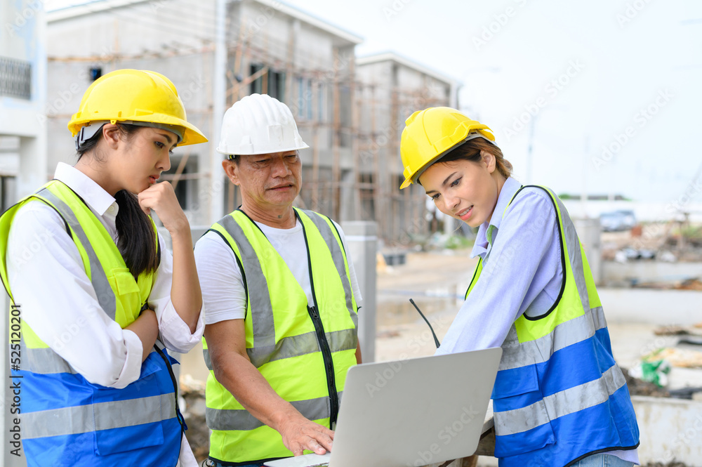 Group of contractors, engineers and formats in vests with helmets working with laptop on under-construction site. Home building project. Engineer foreman discusses with coworker at workplace. Group of contractors, engineers and formats in vests with helmets working with laptop on under-construction site. Home building project. Engineer foreman discusses with coworker at workplace.