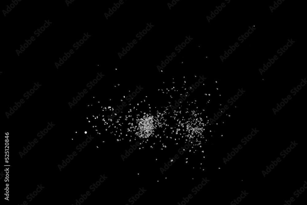 Sifting white caster sugar over black background. Isolated. Sifting white caster sugar over black background. Isolated.