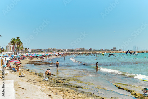 Crowd of people sunbathing on the Torrevieja beach. Spain