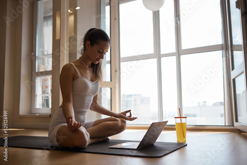 Free Download Attractive young woman doing yoga stretching yoga online at home. Self-isolation is beneficial, entertainment and education on the Internet. Healthy lifestyle concept. - GFXLoad