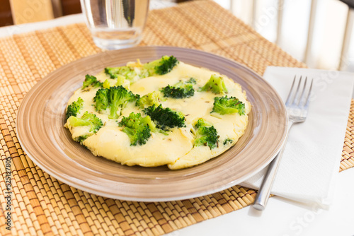 wholesome breakfast. omelet with broccoli on brown plate