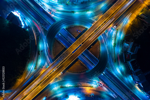 Expressway top view, Road traffic an important infrastructure,car traffic transportation above intersection road in city night, aerial view cityscape of advanced innovation, financial technology 