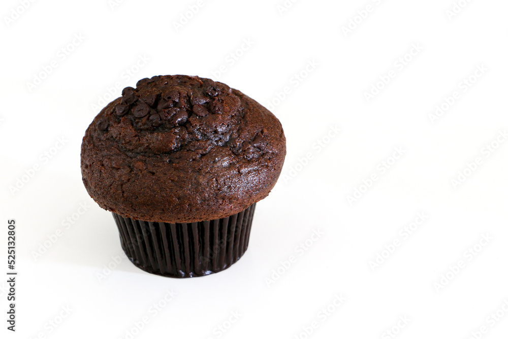 High angle shot of double chocolate muffin cake on the left, isolated by white background High angle shot of double chocolate muffin cake on the left, isolated by white background