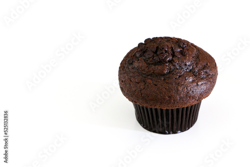 High angle shot of double chocolate muffin cake on the right, isolated by white background