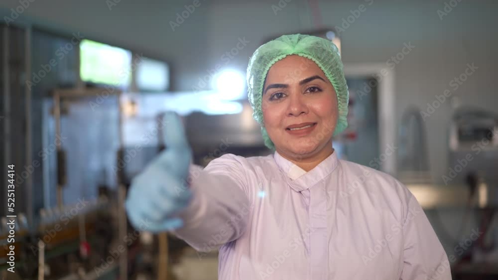Happy Asian female staff in factory's portrait. Happy Asian female staff in factory's portrait.