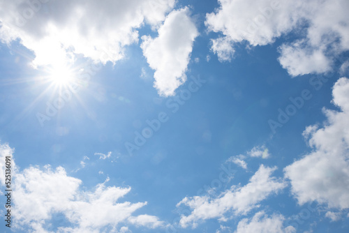 sky background with fluffy clouds and blue space in the middle  sunrays