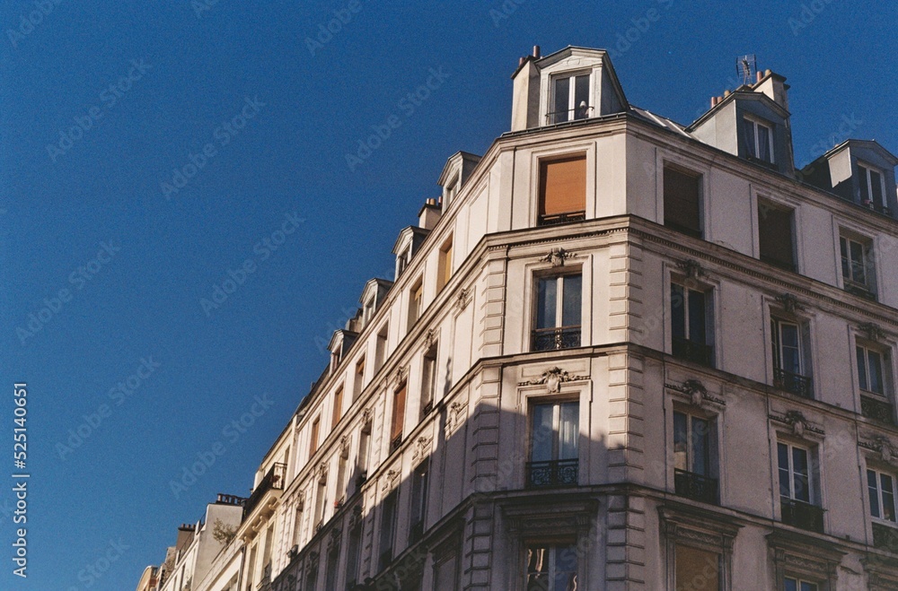 Parisian building photographed on a summer day under a beautiful blue sky, vintage image