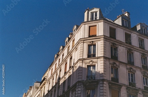 Parisian building photographed on a summer day under a beautiful blue sky, vintage image © Quentin