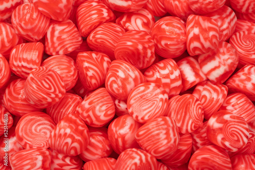 Red round tasty gummy candies as a background.