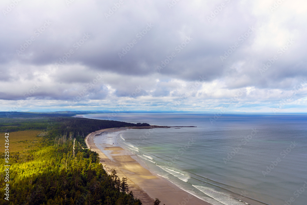 Panoramic aerial view of endless, almost deserted sandy BC beaches at low tide on a cloudy summer day.