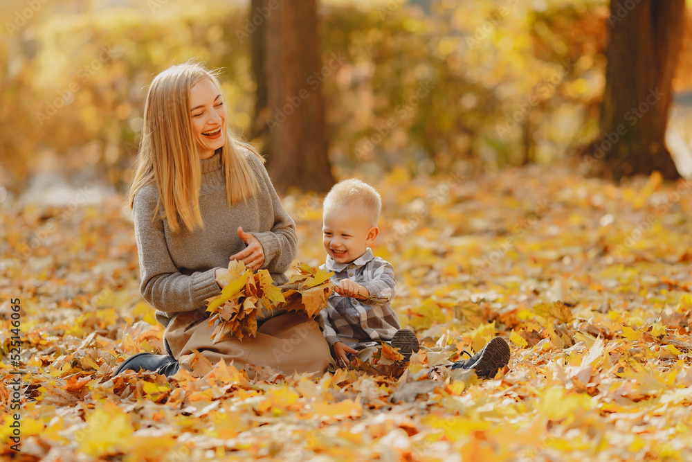 Mother with little son playing in a autumn field Mother with little son playing in a autumn field