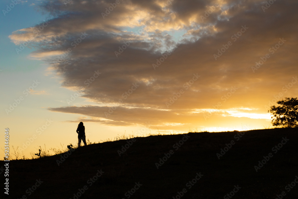 silhouette of a person in the sunset over the mountains silhouette of a person in the sunset over the mountains