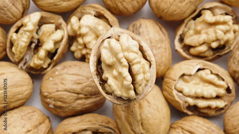 Walnut, split in half, rotates, nuts at the bottom. close-up. Walnut, split in half, rotates, nuts at the bottom. close-up.