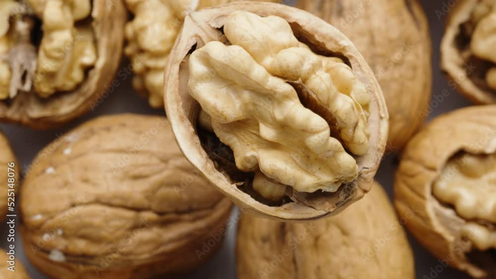Walnut, split in half, rotates, nuts at the bottom. macro. Walnut, split in half, rotates, nuts at the bottom. macro.