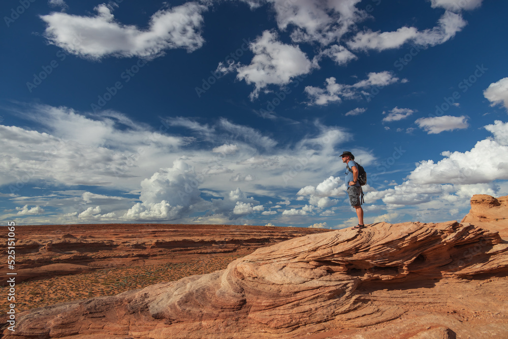 Hiker standing on rock formations on the Beehive trail in Page, Arizona Hiker standing on rock formations on the Beehive trail in Page, Arizona