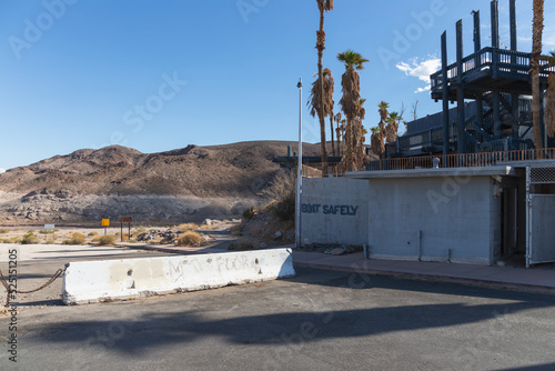 Spray painted sign at closed defunct Echo Bay Marina Lake Mead hotel reads boat safely over blocked launch ramp the water more than a mile away August 2022 photo