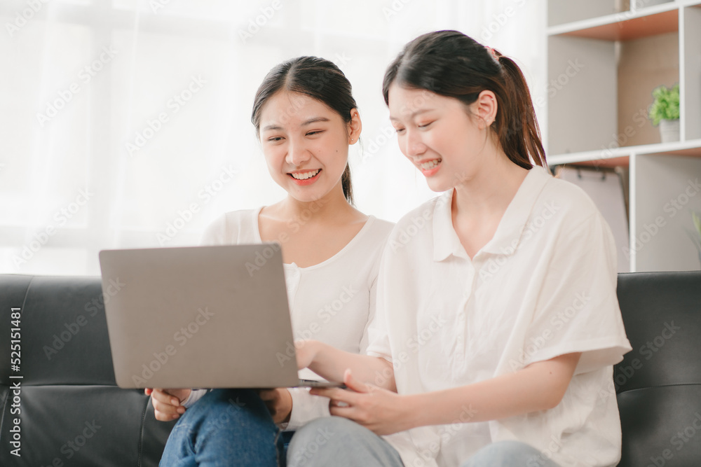 Asian woman happy holding laptop phone sitting sofa smiling good mood indoors indoors Asian woman happy holding laptop phone sitting sofa smiling good mood indoors indoors