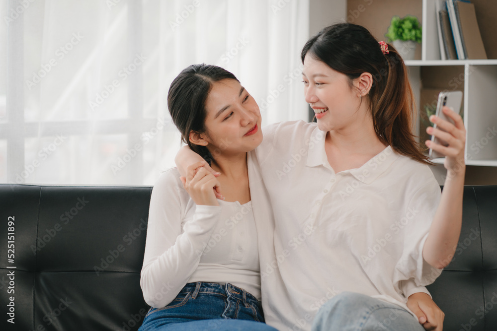 Asian woman happy holding laptop phone sitting sofa smiling good mood indoors indoors Asian woman happy holding laptop phone sitting sofa smiling good mood indoors indoors