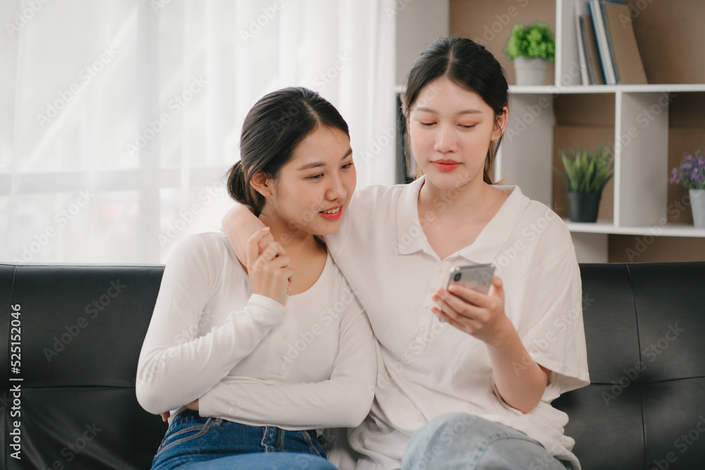 Asian woman happy holding laptop phone sitting sofa smiling good mood indoors indoors Asian woman happy holding laptop phone sitting sofa smiling good mood indoors indoors
