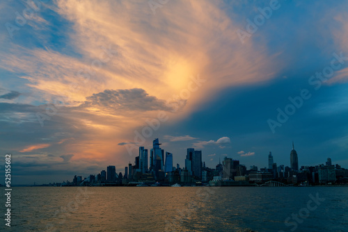 Sunset View to Manhattan skyline Hudson Yards skyscrapers  from Weehawken Waterfront in Hudson River at sunset. High quality photo