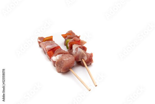 Raw meat and vegetable skewer, isolated on white background. In gastronomy, brochette (from the French brochette, meaning "skewer", "skewered") refers to meals served skewered on a skewer (brochette).
