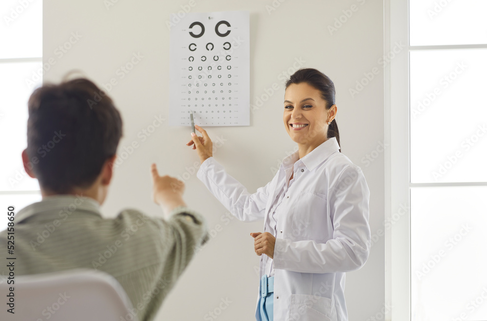Diagnosis of vision in children. Friendly female optometrist is
