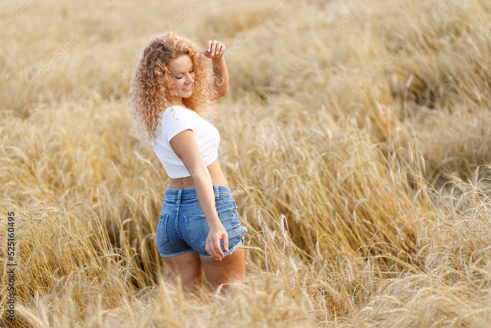 curly-haired girl enjoys a walk in the field curly-haired girl enjoys a walk in the field