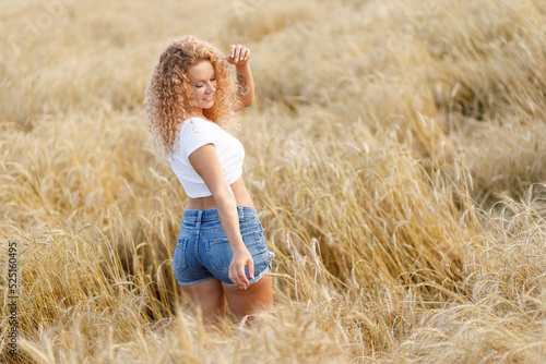 curly-haired girl enjoys a walk in the field