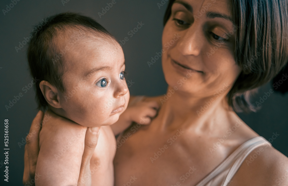 Mom, mummy, young mother with little baby daughter. Mum kissing and hugging child. Newborn cute happy girl smiling in woman hands. Happiness for parents in family. Aged parents, parenting, motherhood Mom, mummy, young mother with little baby daughter. Mum kissing and hugging child. Newborn cute happy girl smiling in woman hands. Happiness for parents in family. Aged parents, parenting, motherhood
