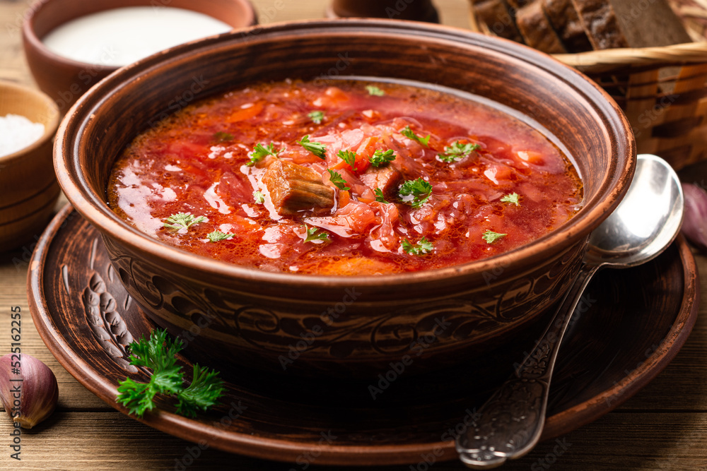 Traditional Ukrainian soup borscht in bowl on wooden background Traditional Ukrainian soup borscht in bowl on wooden background